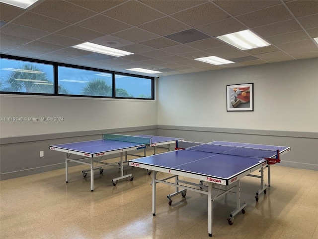 game room with a paneled ceiling