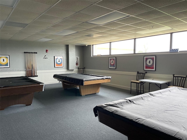 interior space featuring carpet flooring, pool table, and a paneled ceiling