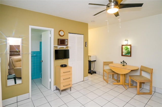 kitchen featuring light tile patterned flooring, white fridge, ceiling fan, stainless steel electric range oven, and sink