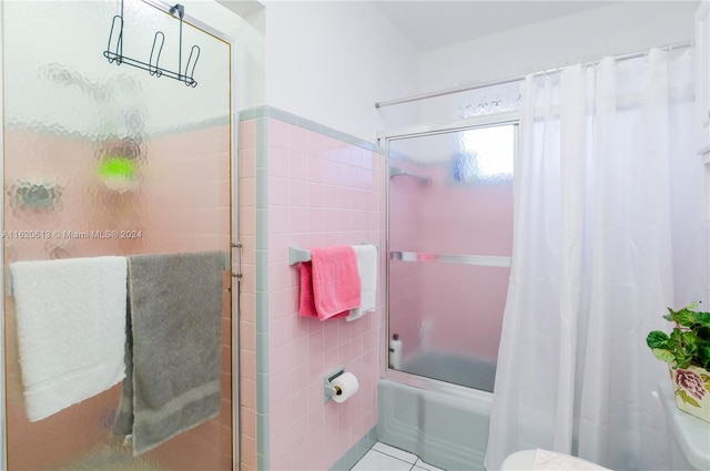 bathroom with toilet, tile patterned floors, decorative backsplash, and tile walls