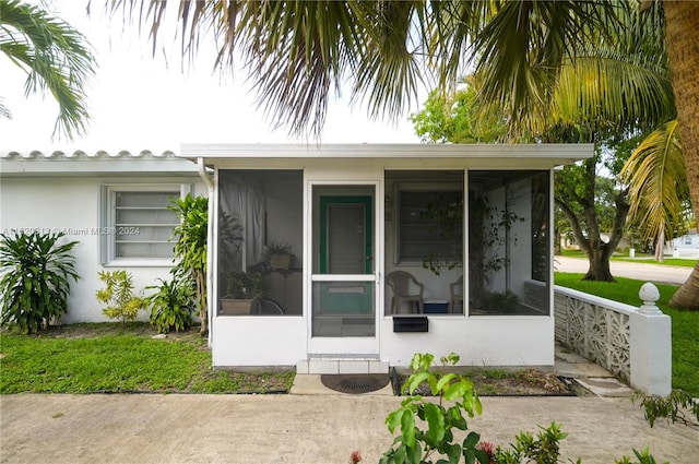 view of side of home featuring a sunroom