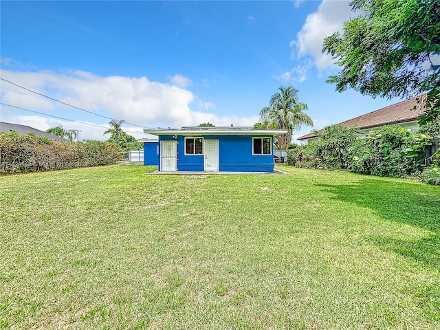 rear view of house with a lawn