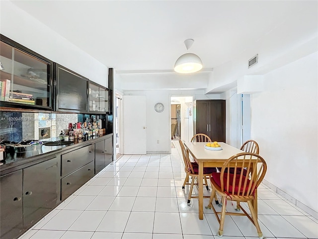 kitchen featuring dark brown cabinets and light tile patterned floors