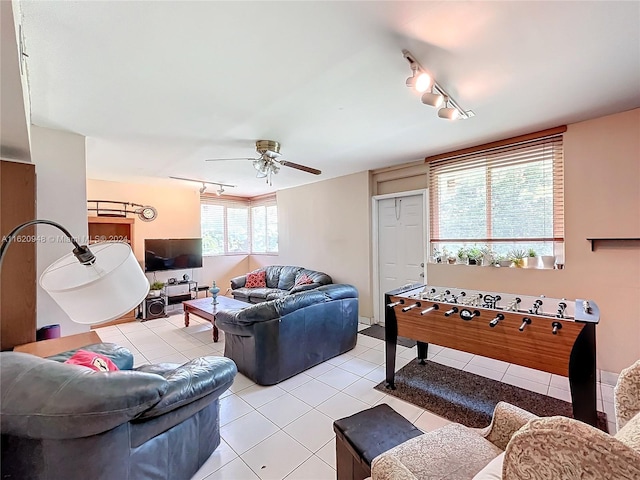 tiled living room featuring rail lighting and ceiling fan