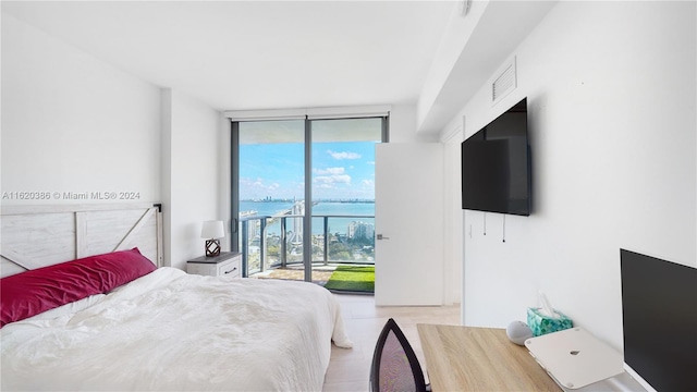 bedroom featuring floor to ceiling windows and access to exterior