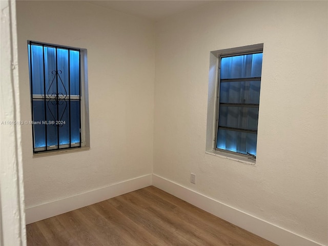 unfurnished room with hardwood / wood-style floors