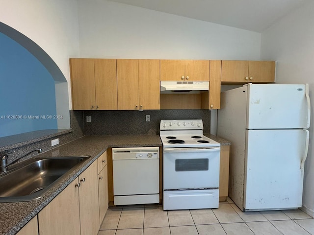 kitchen featuring white appliances, light tile patterned floors, tasteful backsplash, vaulted ceiling, and sink