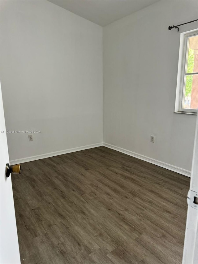 empty room with dark hardwood / wood-style floors