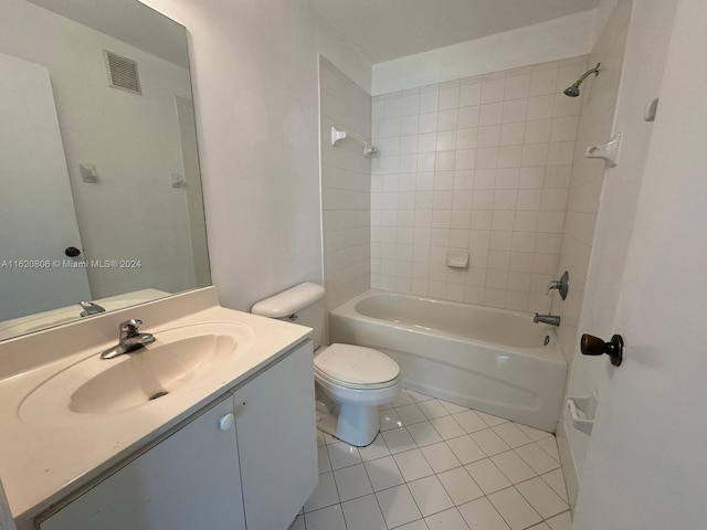 full bathroom featuring vanity, tiled shower / bath combo, toilet, and tile patterned flooring