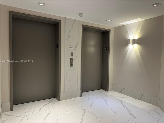 interior space featuring marble finish floor and elevator