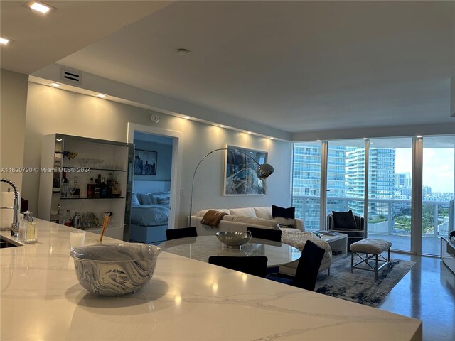 living room with sink and floor to ceiling windows