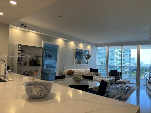 living room with a view of city, a wall of windows, and visible vents