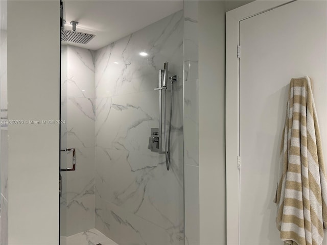 full bathroom featuring marble finish floor and a marble finish shower