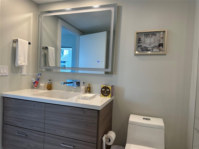 bathroom featuring vanity and toilet