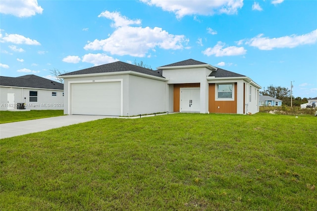 prairie-style home with a front lawn and a garage