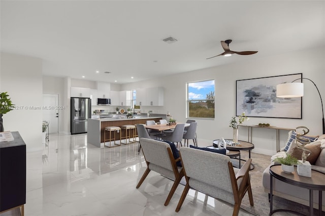 dining room featuring ceiling fan and sink