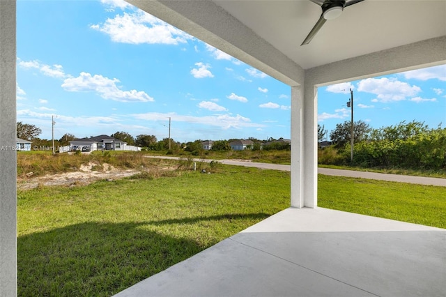 view of yard featuring ceiling fan and a patio area