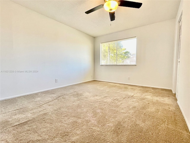 unfurnished room featuring carpet floors, a textured ceiling, and ceiling fan