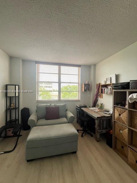 interior space featuring a textured ceiling and hardwood / wood-style floors