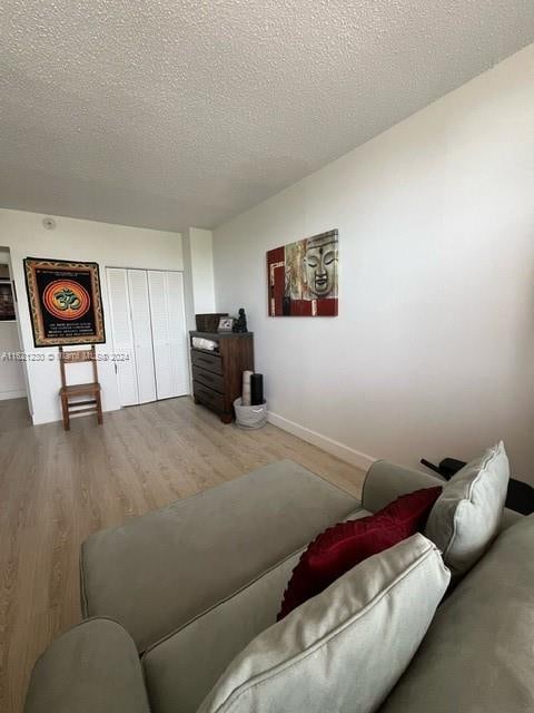 living room featuring a textured ceiling and hardwood / wood-style flooring