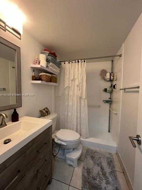 bathroom with walk in shower, tile patterned floors, toilet, and vanity