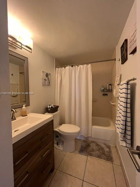 full bathroom with tile patterned flooring, shower / bath combination with curtain, toilet, and vanity