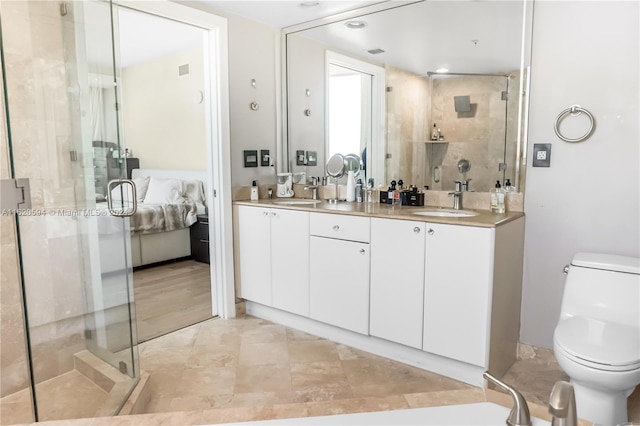 bathroom with a shower with door, tile patterned flooring, toilet, and dual bowl vanity