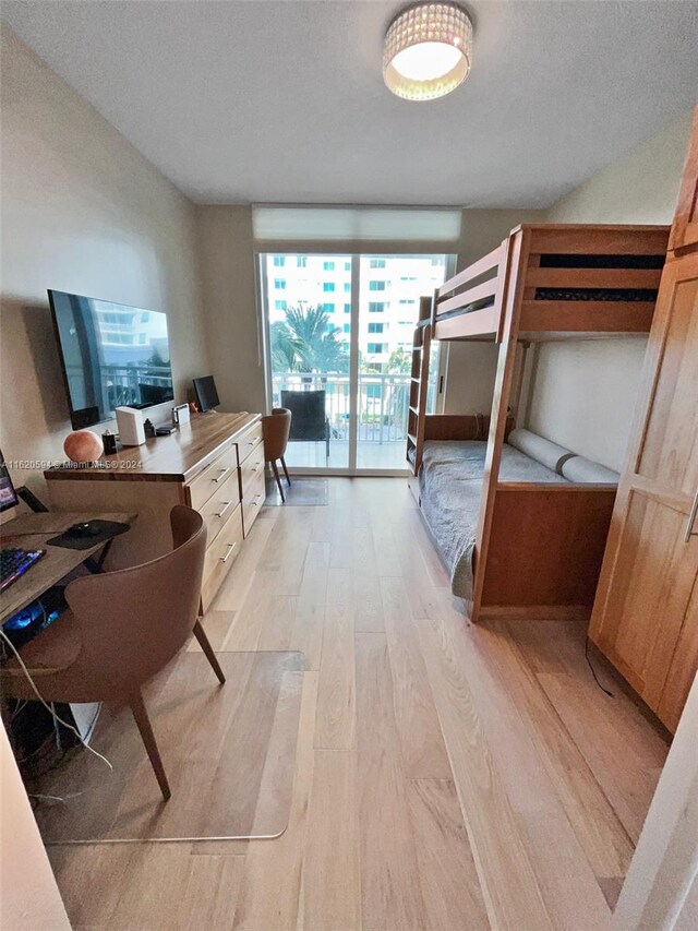 1745 E Hallandale Beach Blvd Unit 303W, Hallandale Beach, FL 33009 - bedroom with light wood-style flooring, an office area, and access to outside