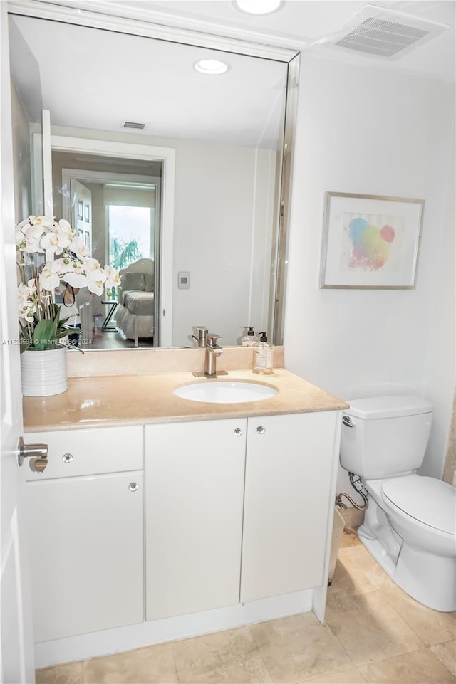 bathroom featuring vanity, toilet, and tile patterned floors