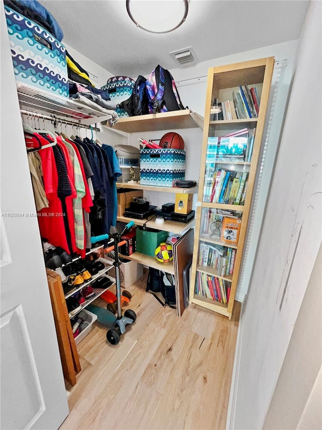 spacious closet with hardwood / wood-style floors