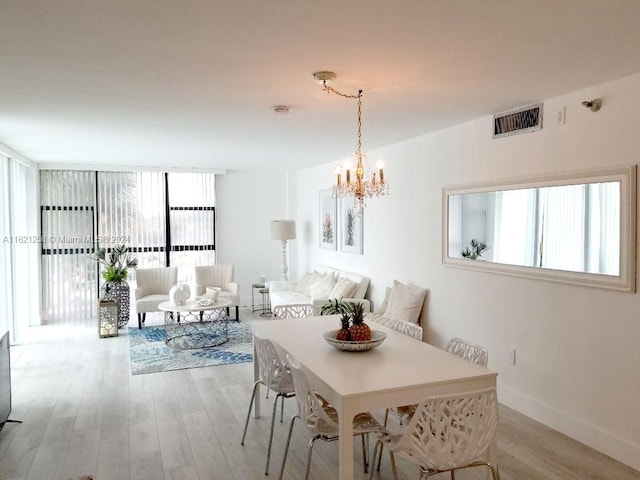 dining space with an inviting chandelier and wood-type flooring