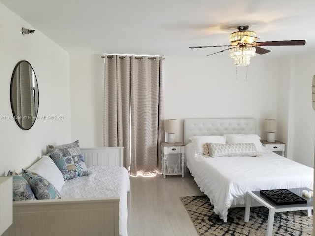 bedroom with wood-type flooring and ceiling fan