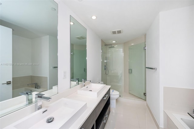 full bathroom with tile patterned flooring, vanity, independent shower and bath, and toilet