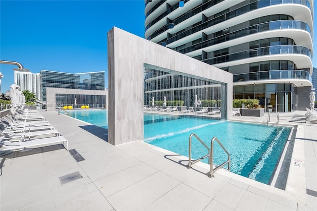 view of swimming pool with a patio area and pool water feature