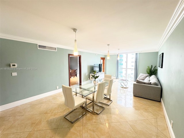 tiled dining space with crown molding and floor to ceiling windows