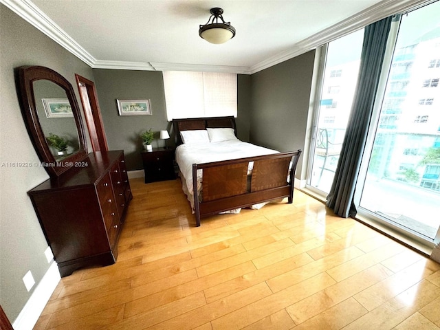 bedroom featuring a wall of windows, crown molding, and light hardwood / wood-style floors