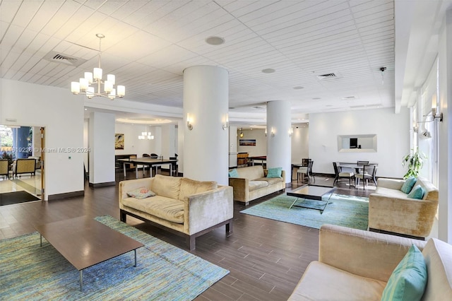 living room featuring an inviting chandelier and dark hardwood / wood-style floors