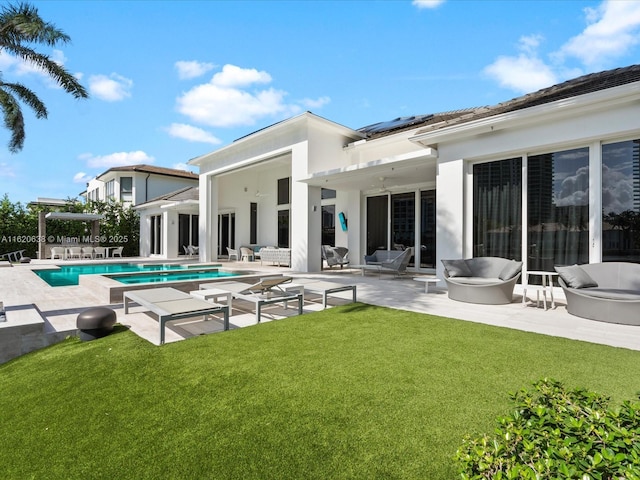 rear view of property with a patio, a yard, a pergola, and an outdoor pool