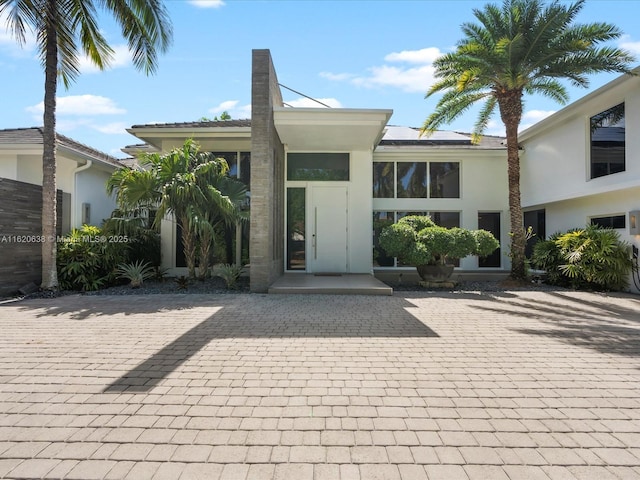 view of front of home with a patio area and stucco siding