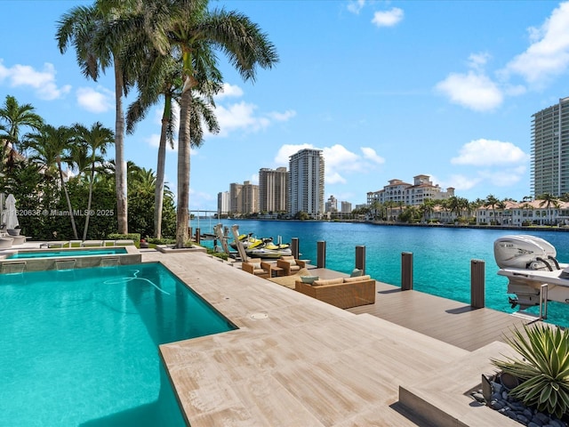 view of swimming pool with a view of city, a pool with connected hot tub, a water view, and a boat dock