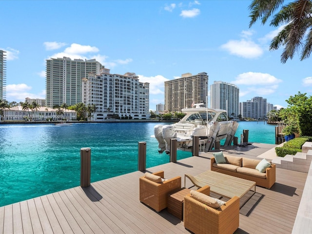 view of dock featuring a city view, a water view, and boat lift