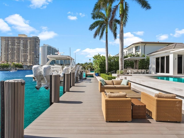 dock area featuring a view of city, outdoor lounge area, a water view, and an outdoor pool