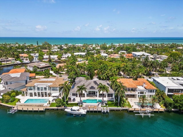 drone / aerial view with a water view and a residential view