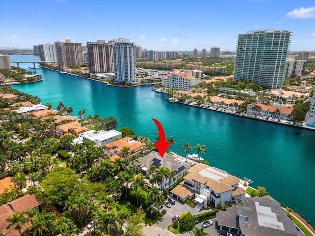 birds eye view of property with a water view and a view of city