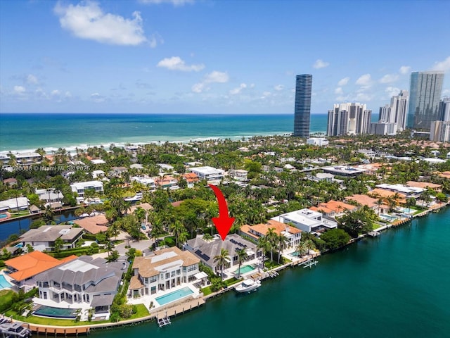 drone / aerial view featuring a view of city and a water view