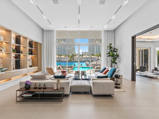 living area featuring a towering ceiling and a wealth of natural light