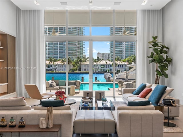 living room featuring a water view and a city view