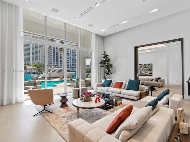 living room with floor to ceiling windows and a towering ceiling