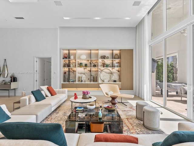 living room featuring visible vents and a towering ceiling