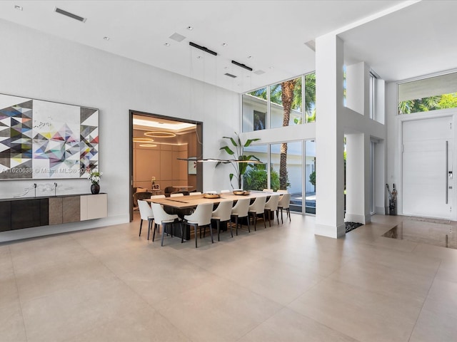 dining room with a high ceiling and visible vents